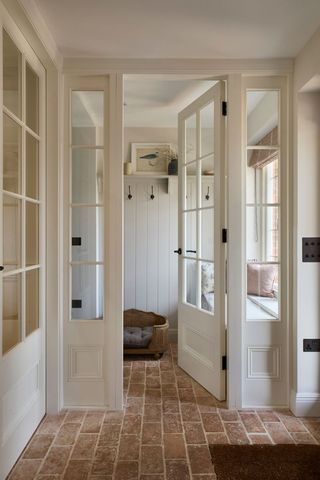 white hallway with terracotta tiles