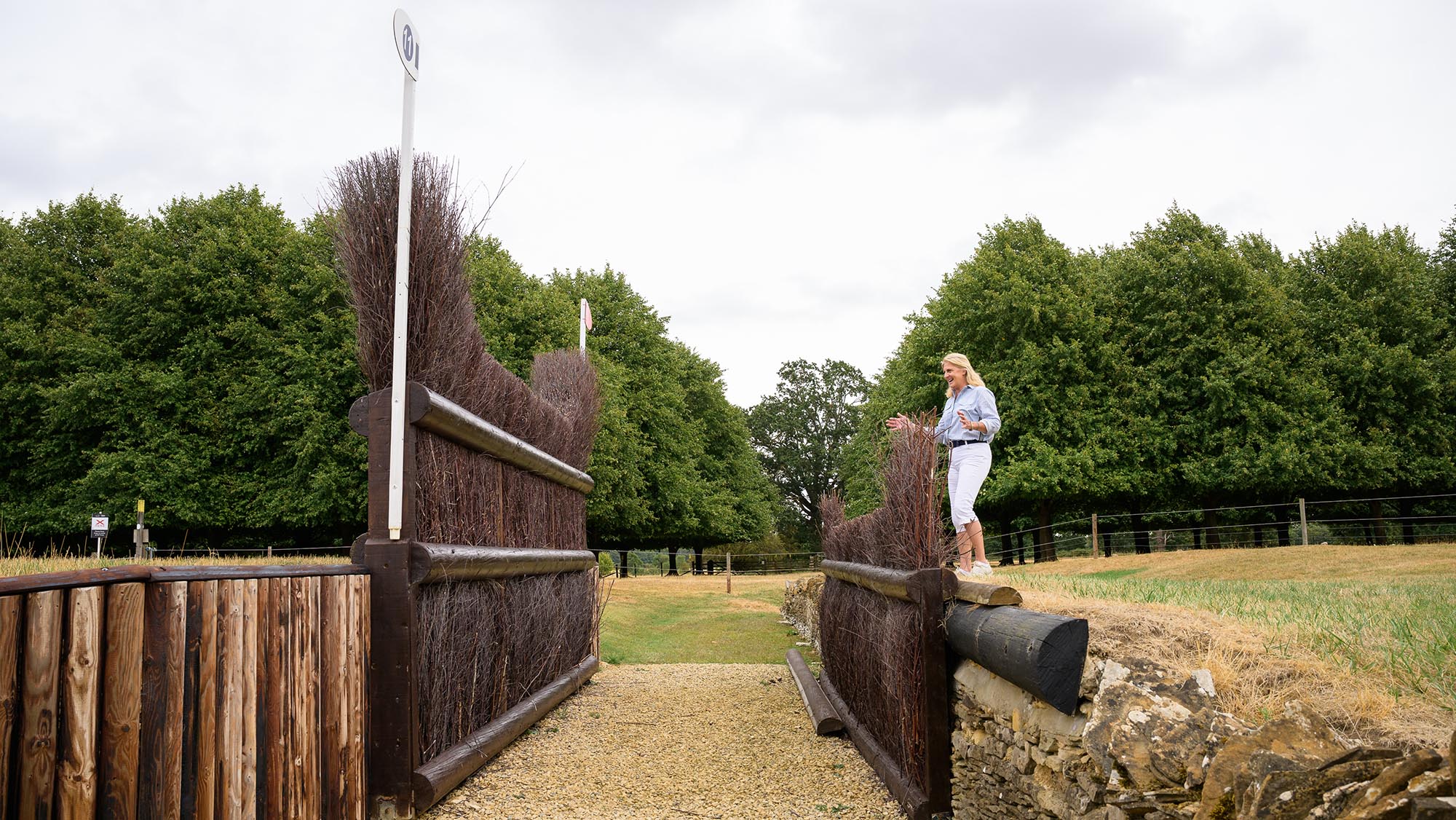 Event rider Tina Cook standing in front of a big ditch before a brush fence on the Burghley cross-country course 2026