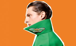 brightly coloured background with man wearing Boucheron butterfly brooch on collar