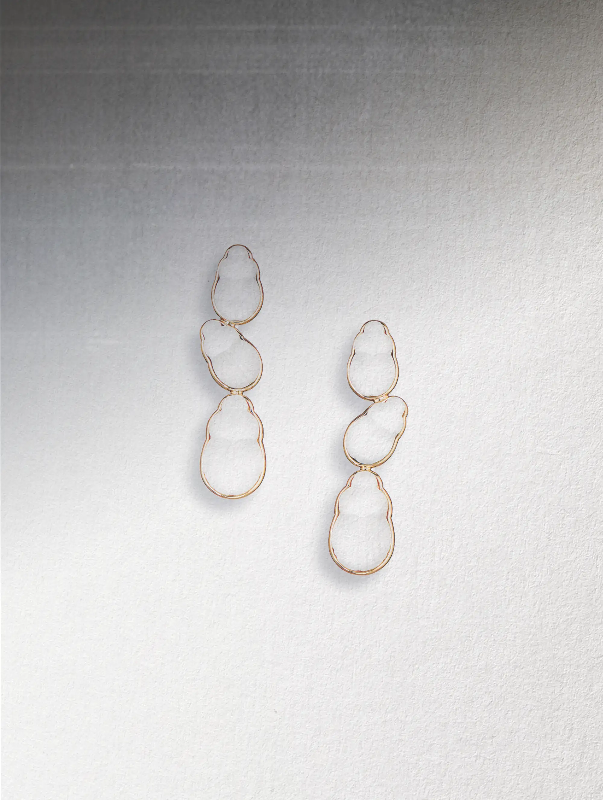 Bianca earrings by Lito which have three white droplets framed in gold