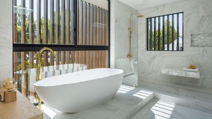 A clean bathroom with gold fixtures