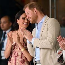 Meghan Markle smiles at Prince Harry while on a tour of Colombia