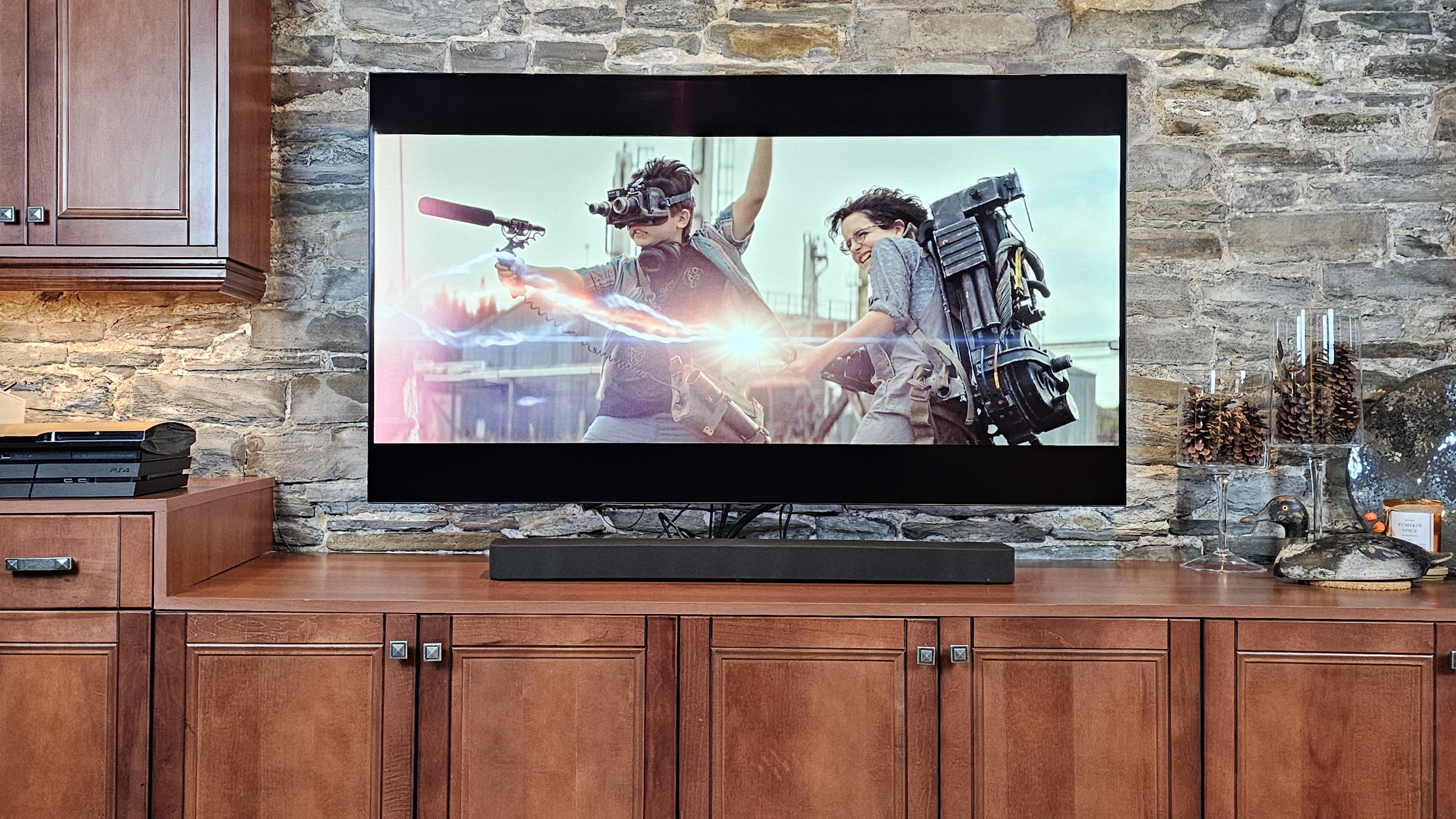 The Sony Brave Theater Bar 7 pictured under a TV and on a wooden cabinet
