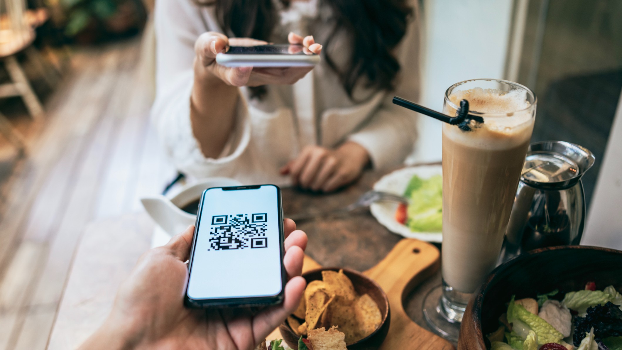 a friend sending a QR code of their payment app to their friend to split lunch 