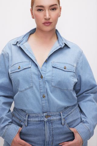 a model wears a denim shirt with jeans
