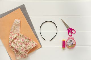 The supplies you need to make bunny ears at home laid out on a table.