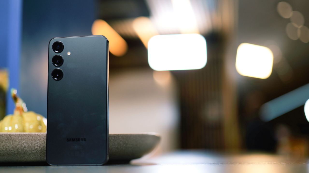 Samsung Galaxy S24 Plus phone propped against a plate