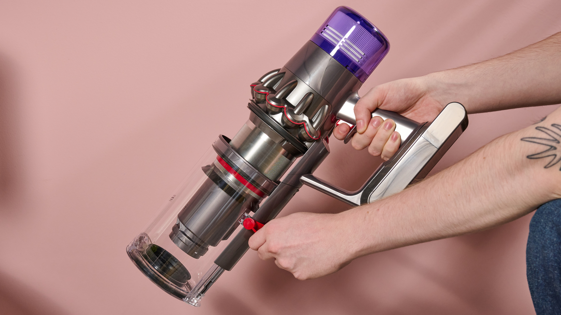 Dyson V11 stick vacuum with bin emptying slider being demonstrated