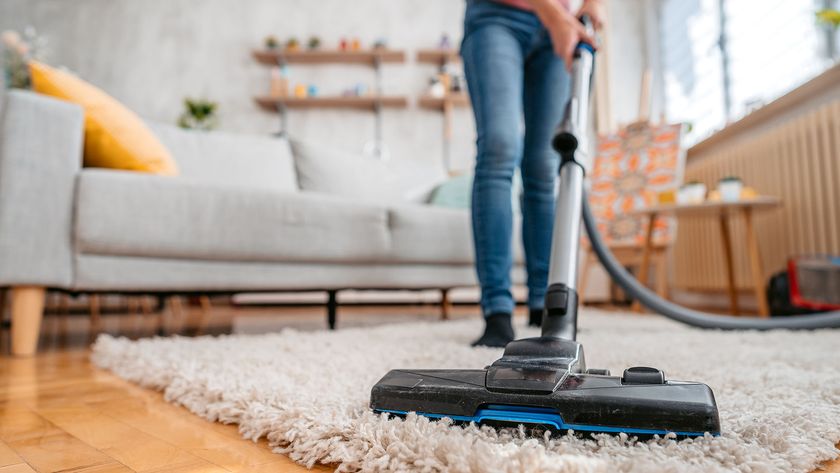 Person vacuuming a rug