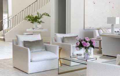 neutral modern living room with flowers on the coffee table by Marie Flanigan