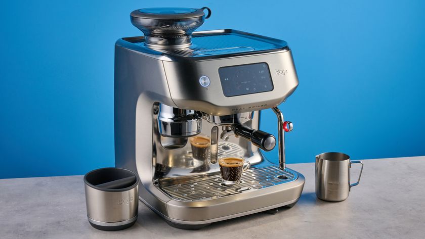 the breville oracle dual boiler / sage oracle dual boiler in stainless steel, showing its touchscreen, steam wand, built in grinder, and espresso shots