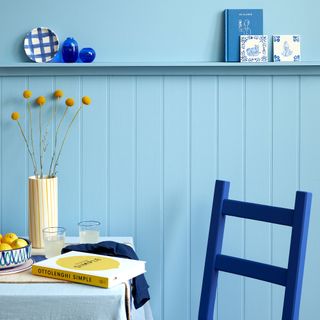 Blue wall with dark blue chair