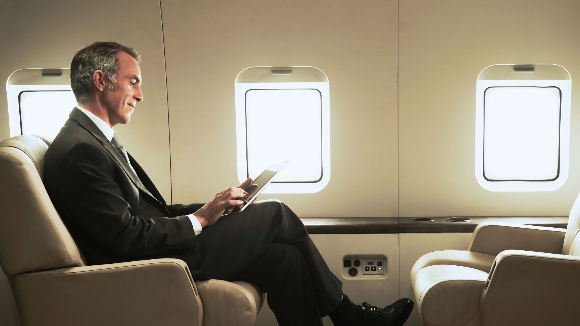 Business man travelling aboard a private jet