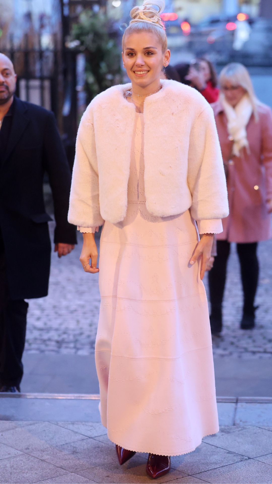 katie melua wearing a pink dress and fur jacket