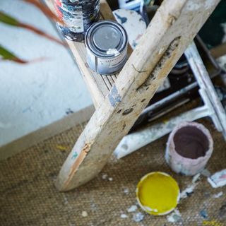 A ladder with paint tins