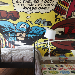 child room with printed cartoon wall and wooden flooring