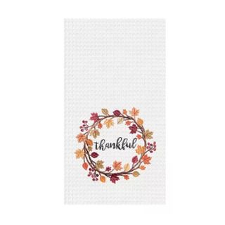A white tea towel that says "Thankful" with a wreath around it