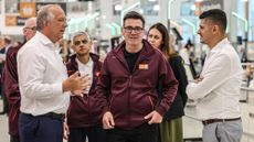 Andy Burnham and Sadiq Khan wearing Sainsbury's uniform in a store in Nine Elms