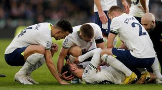 Tottenham midfielder Rodrigo Bentancur receives treatment after suffering an injury against Leicester in the Premier League in February 2023.