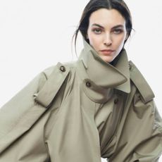 Woman wearing green COS trench coat