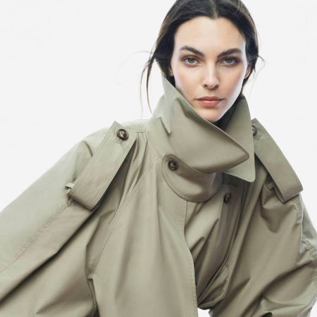 Woman wearing green COS trench coat