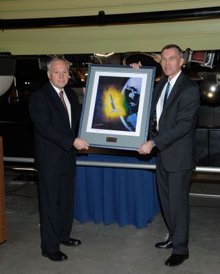 Presentation of a Painting of the Hexagon Satellite