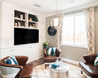 A white media wall with ample storage in a modern living room