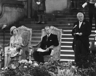 The Queen and Prince Philip listening to an address by Harold Wilson
