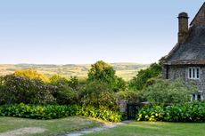 A much-loved view over the mounding roses and bergenias to the Dorset landscape beyond. Credit: Jason Ingram