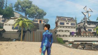 A player in a blue outfit looking at a settlement on a beach in pre-alpha screenshot of Stars Reach.