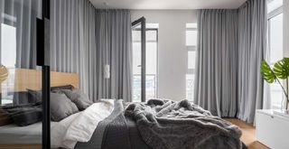 gray bedroom with custom drapery on walls to show a key bedroom trend for 2023