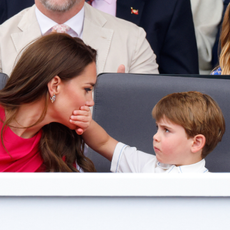 Prince Louis of Cambridge covers his mother Catherine, Duchess of Cambridge's mouth with his hand as they attend the Platinum Pageant on The Mall on June 5, 2022 in London, England.