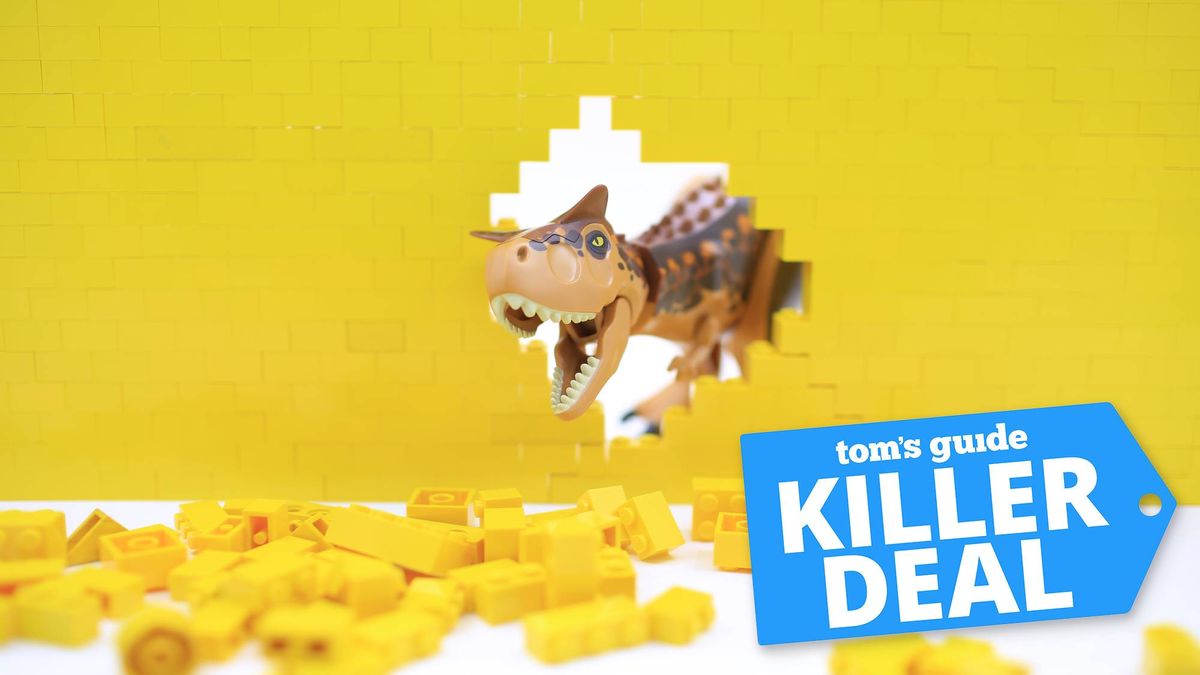 A Lego dinosaur crashing through a yellow Lego wall