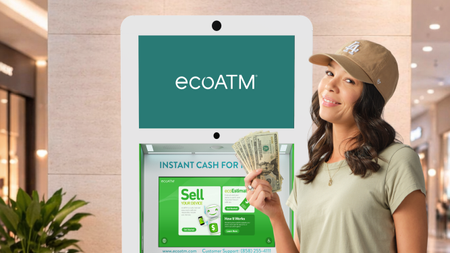Woman holding cash next to an Ecoatm machine