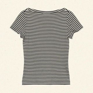 A cutout of a black and white stripe tshirt from Dôen, shot against a cream background