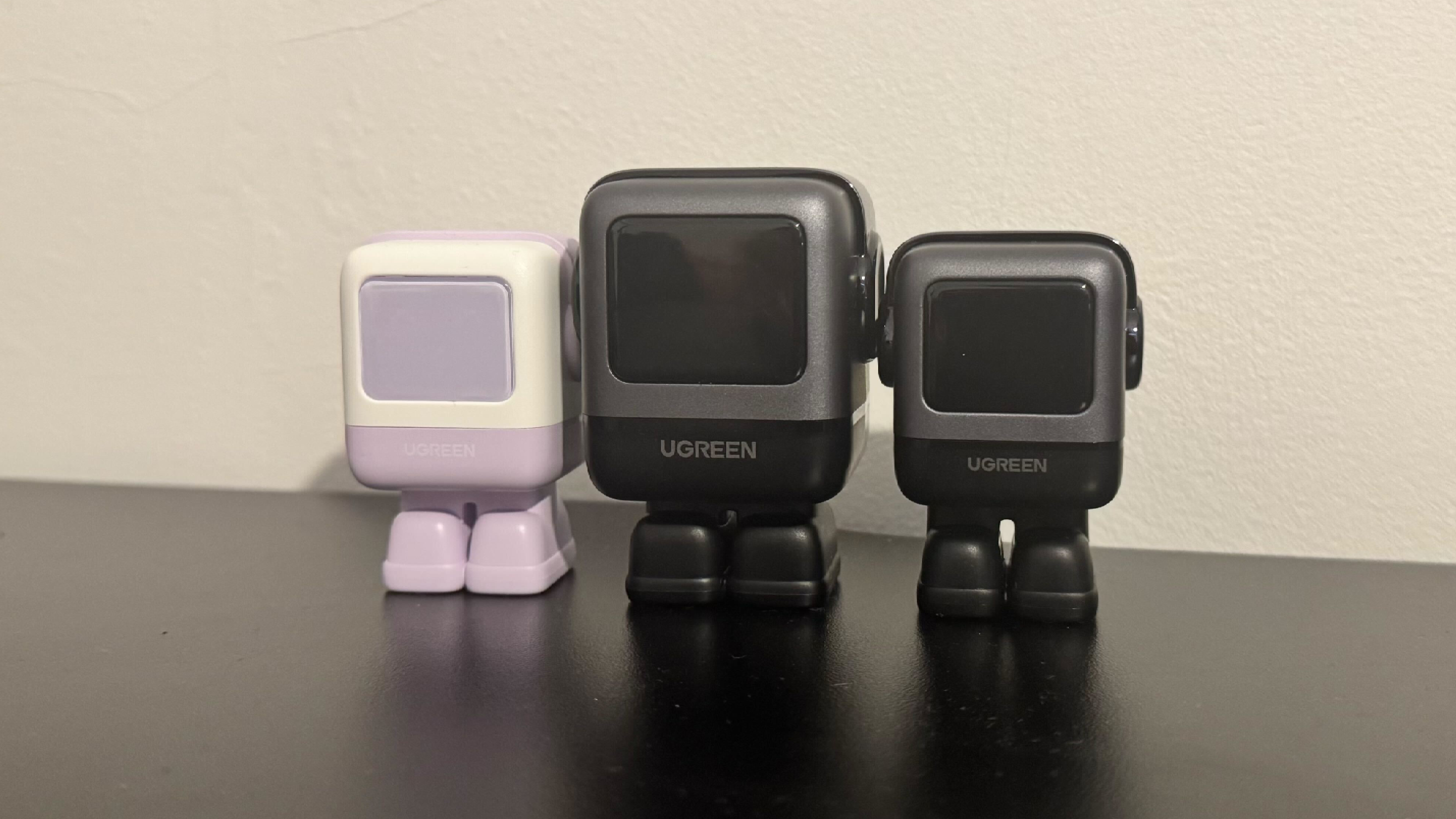 Three UGreen robot fast chargers, sitting on a desk