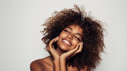 Beautiful afro woman with perfect make-up - stock photo