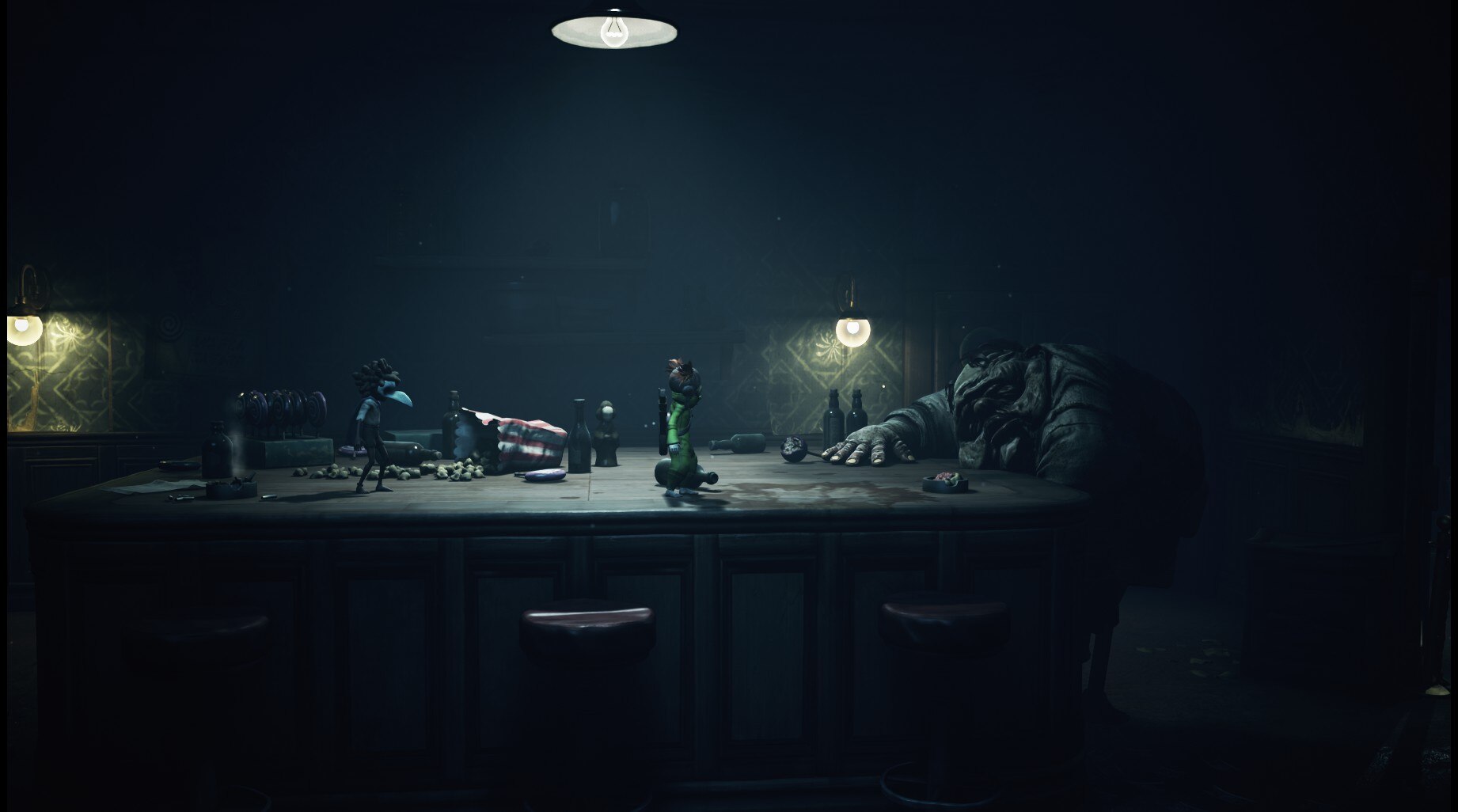 Two tiny figures stand on a messy table, looking at a grotesque sleeping figure