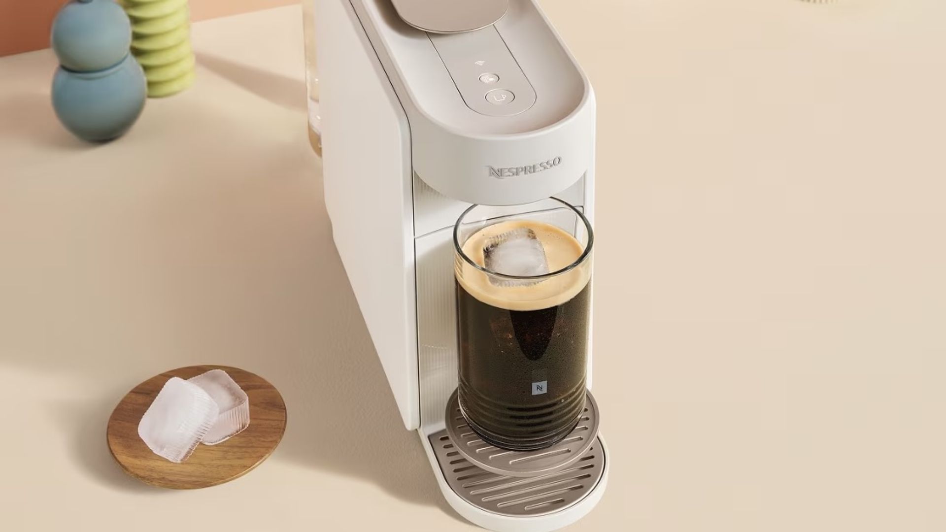 Nespresso Vertuo Up coffee machine with an iced coffee brewed inside it