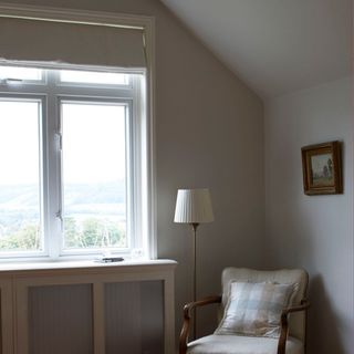 white wall with window and arm chair