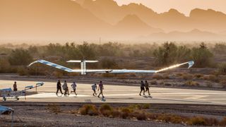 Flight crews help the Zephyr drone take off.