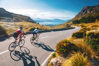 image of two cyclists riding in sunny conditions