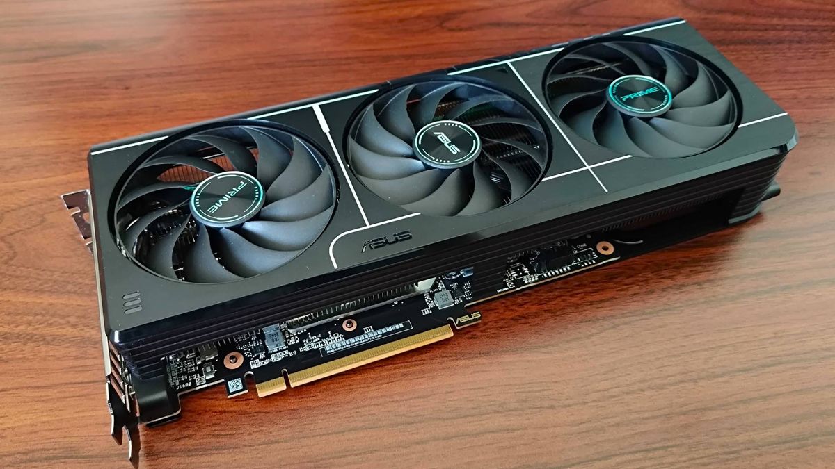 AMD Radeon RX 9070 graphics card lying on woodgrain desk at an angle.