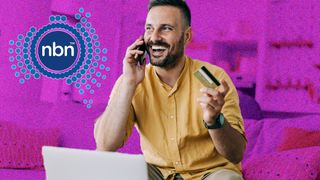 Man sitting at computer looking happy and holding a credit card, with a pink background and the NBN logo to the top left
