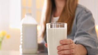 woman holding glass of milk