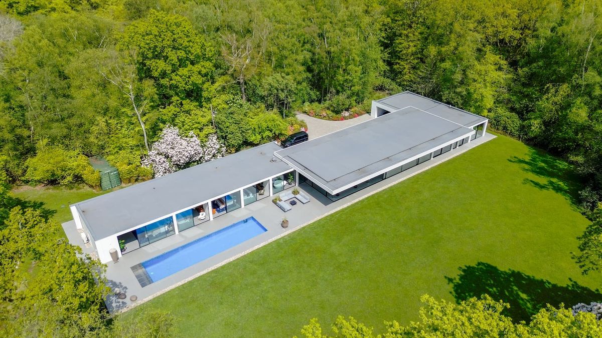 An overhead shot of a long self build one-storey home with a pool