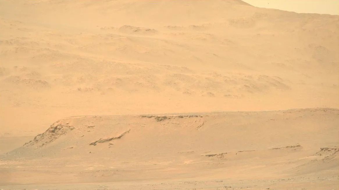 A desert looking scene with rocky area in the far ground.