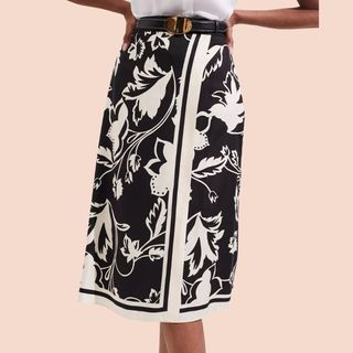 Cropped image of woman wearing black and white printed skirt