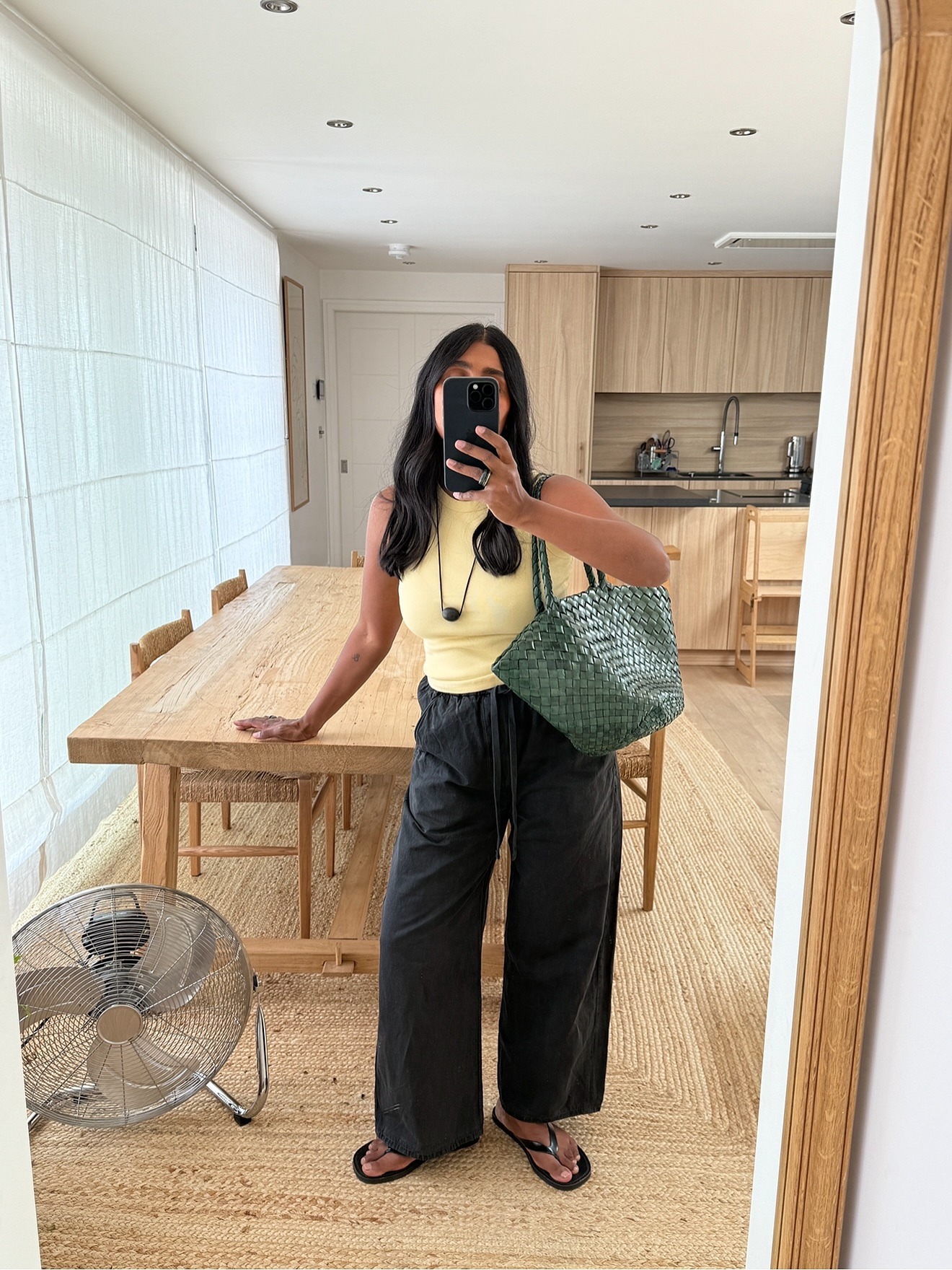 @Monikh wears linen trousers and a tank top look.