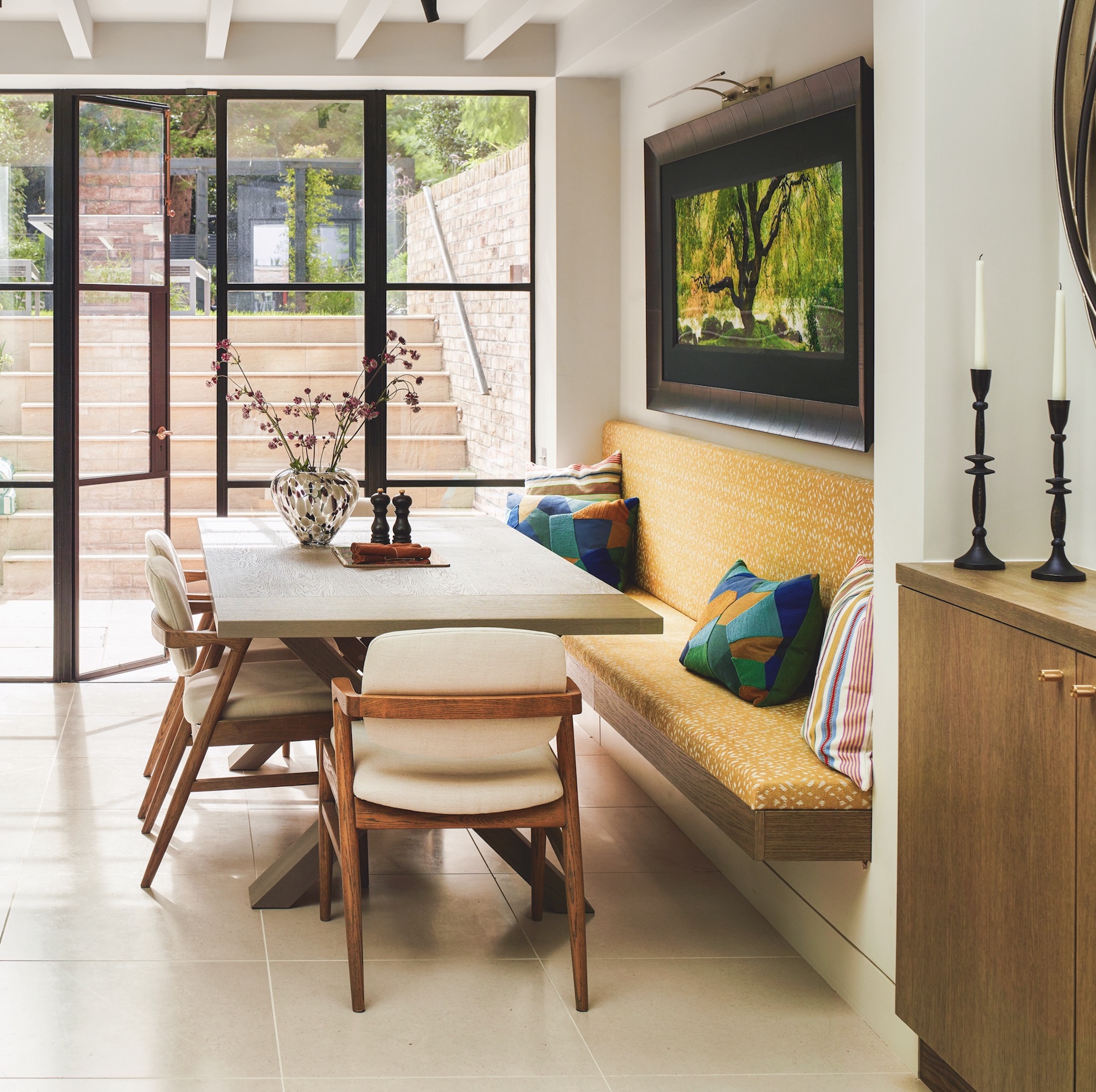 dining area in basement kitchen diner with wooden table and yellow banquette seat